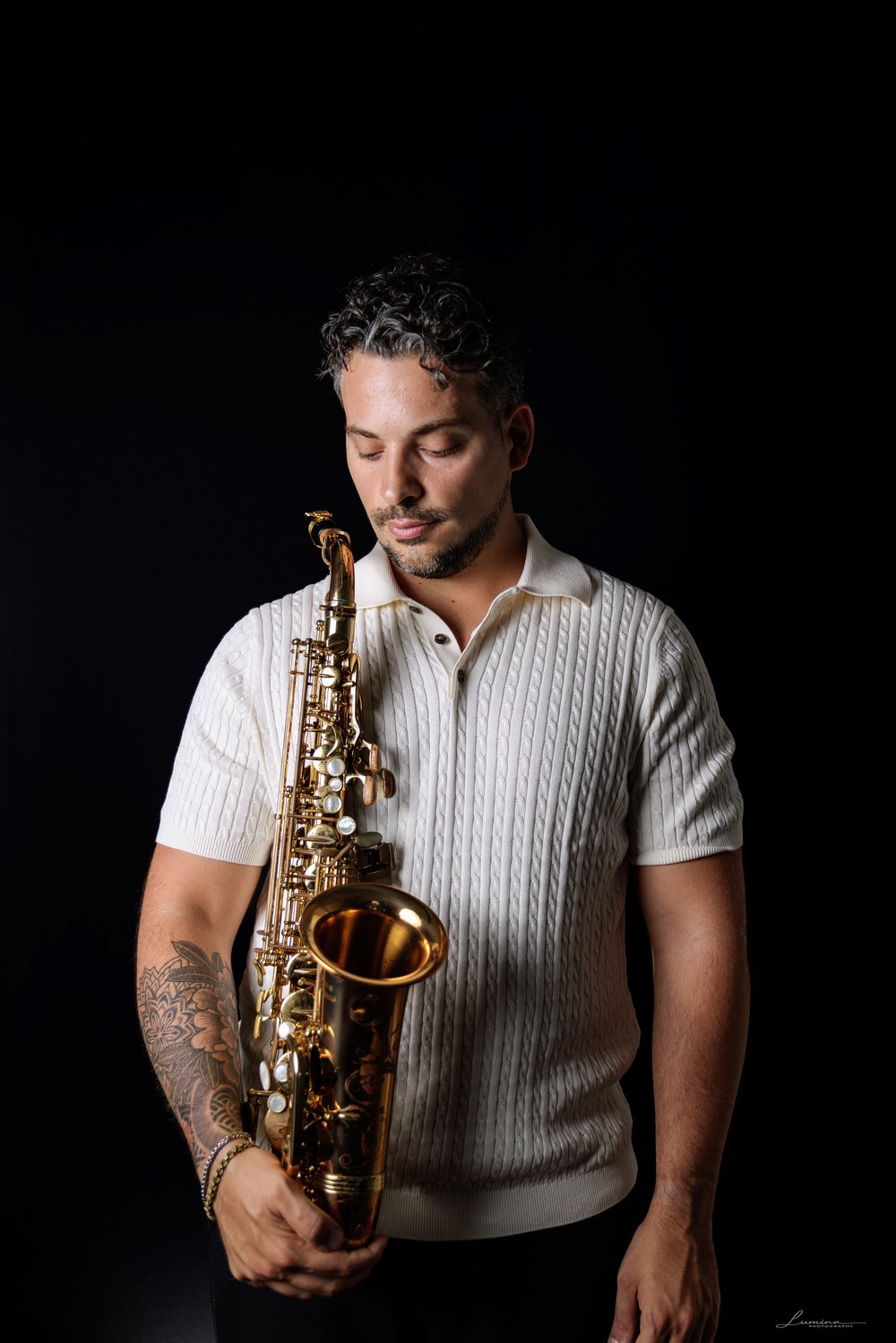 Rodrigo Belga playing saxophone outdoors, close-up portrait